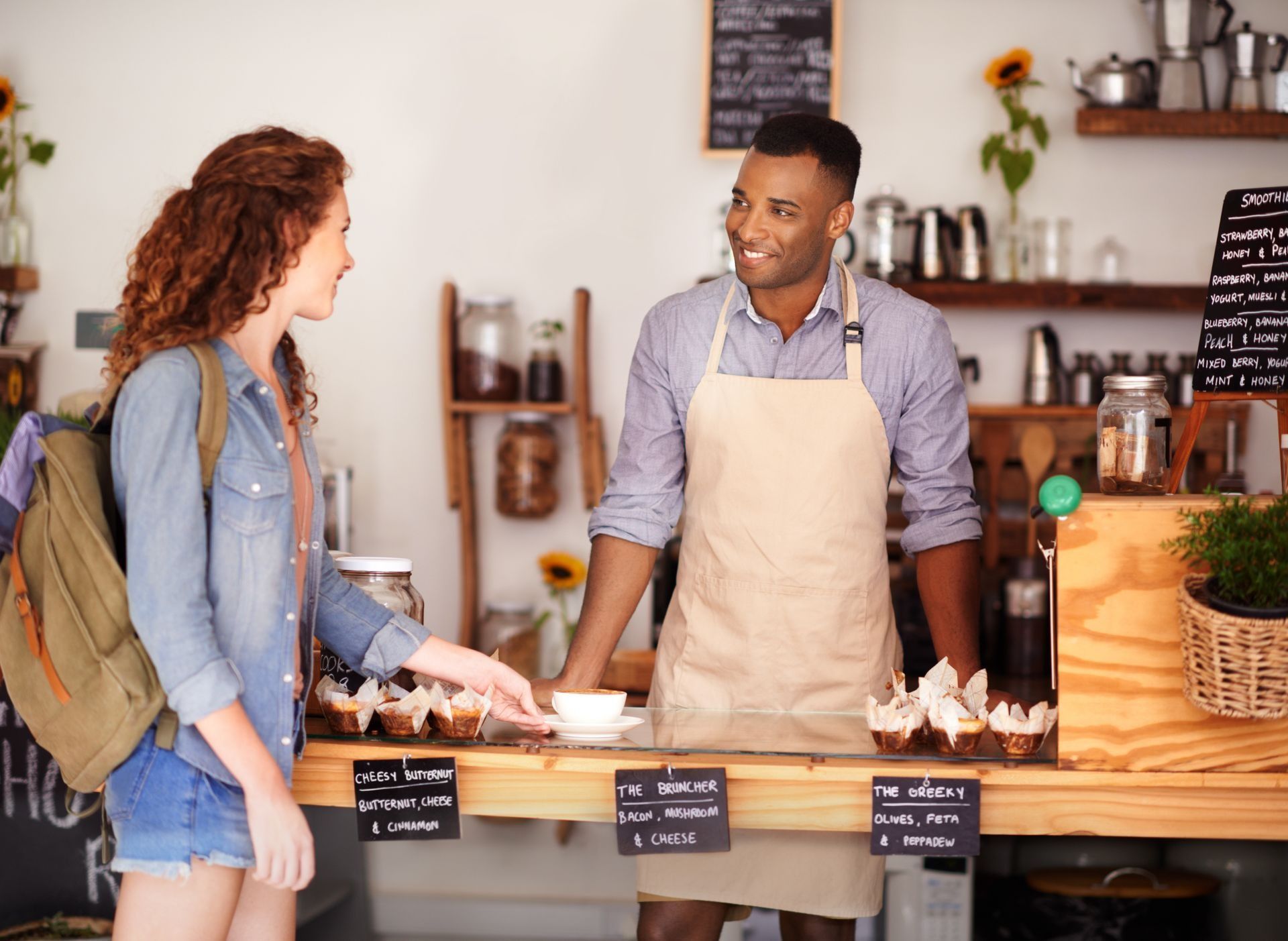 A doctor is sitting at a table talking to two elderly people.