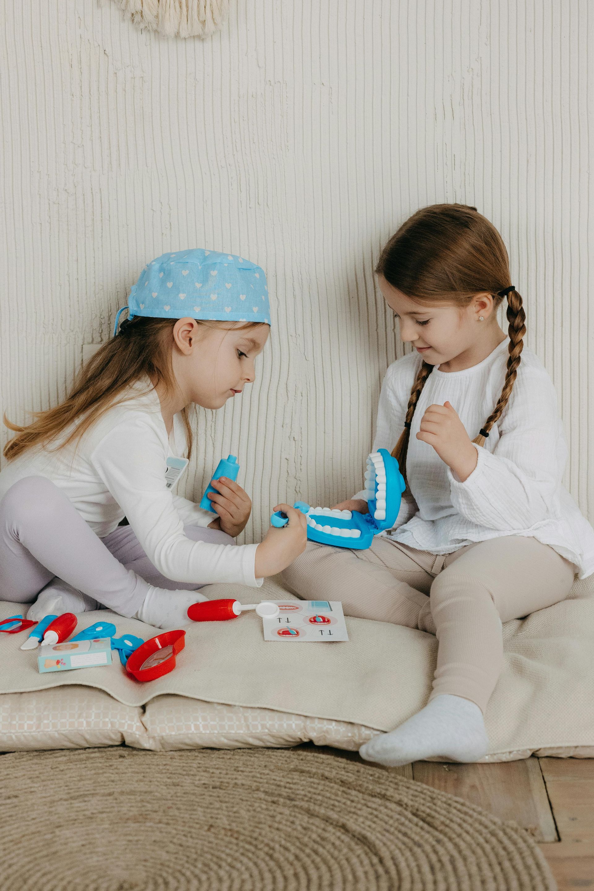 A man and a woman are sitting at a desk looking at a computer screen.