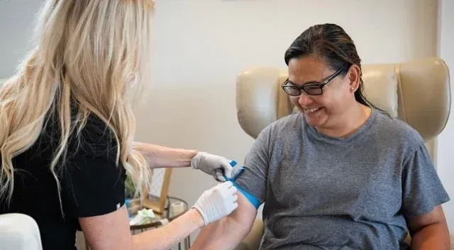 Woman getting an IV injection at VitaTherapy.