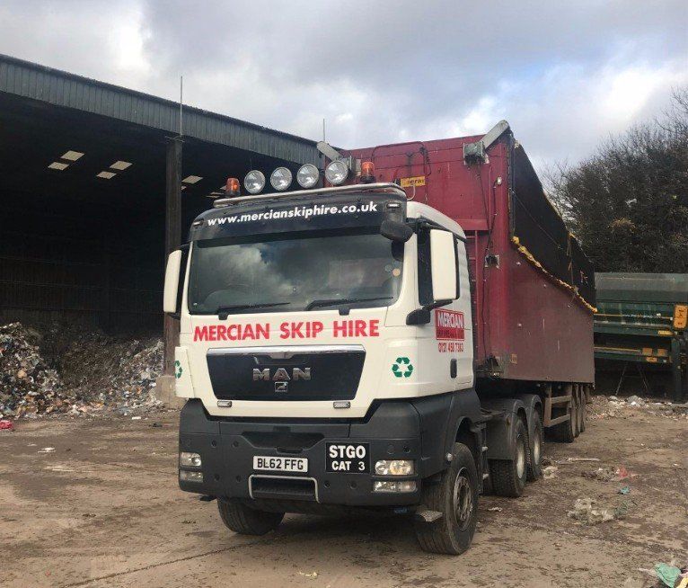 Lorry with loaded skip on the back