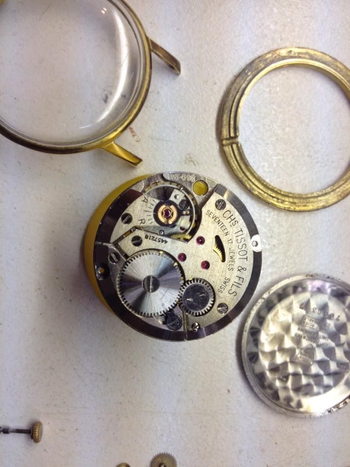 A Tissot Watch Is Being Disassembled On A Table — Tinonee Clock Repairs in Tinonee, NSW