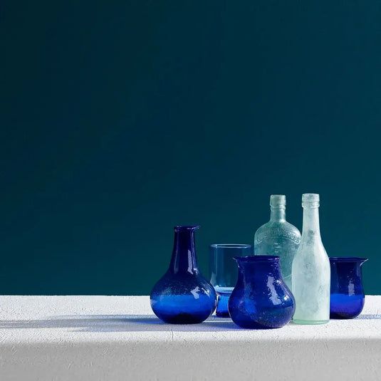 Blue Glass Bottles and Vases on a White Surface — GV painting in Shepparton, VIC