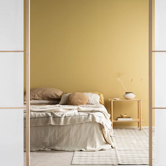 Bedroom With a Yellow Wall, Bed With Linen Bedding — GV painting in Shepparton, VIC
