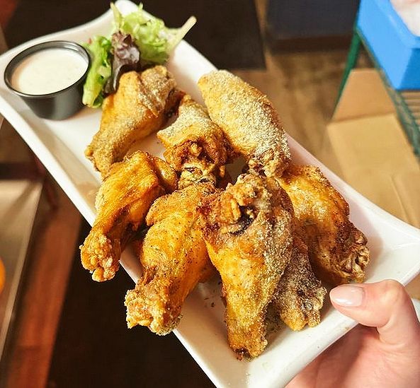 plate of chicken wings with ranch dressing