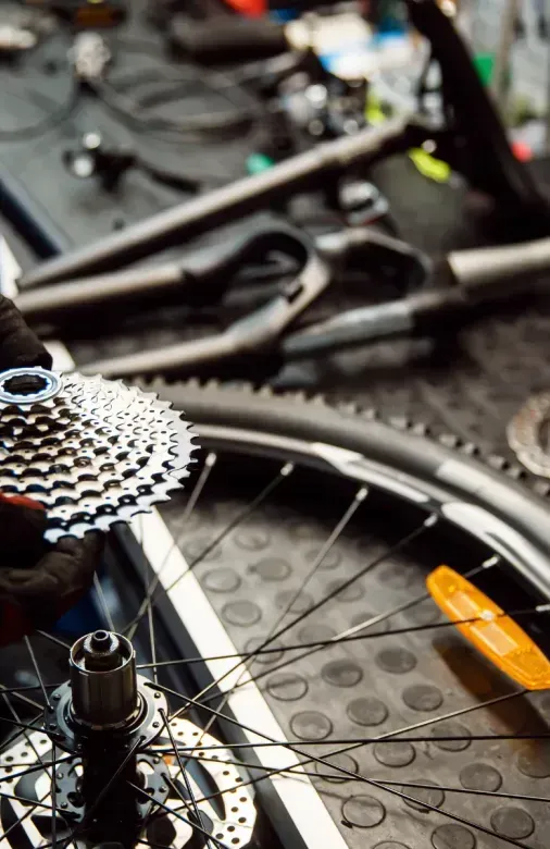 A person is working on a bicycle in a workshop.