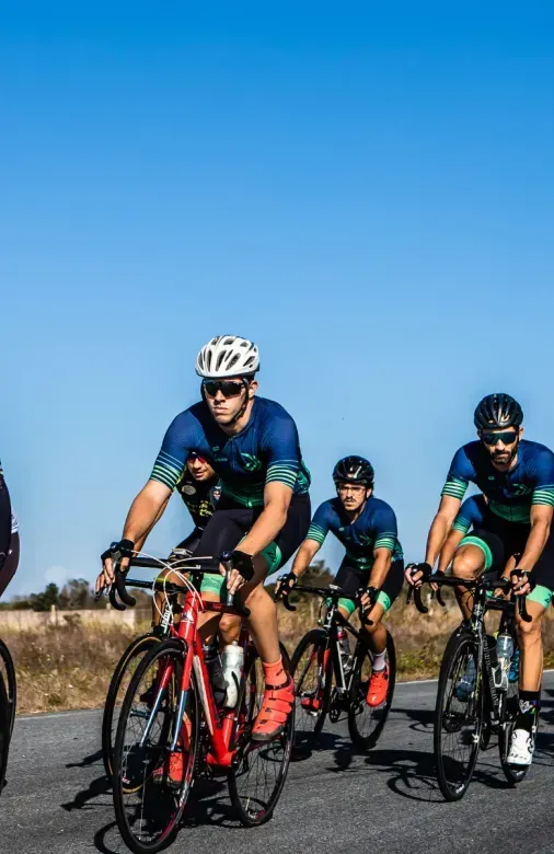 A group of people are riding bicycles down a road.