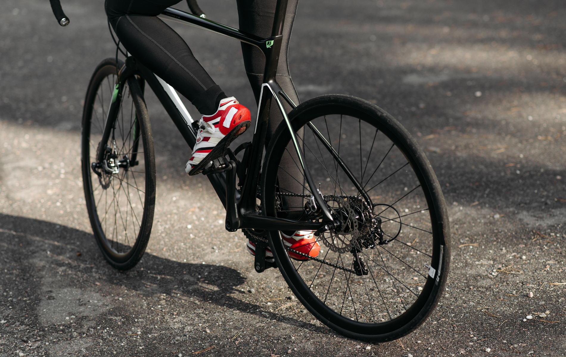 A person is riding a bike on a road.