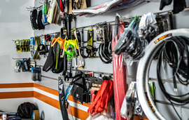 A bunch of bicycle parts are hanging on a wall in a store.