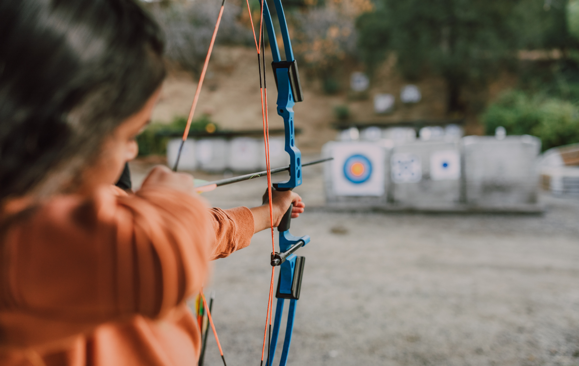 girl shooting with archer