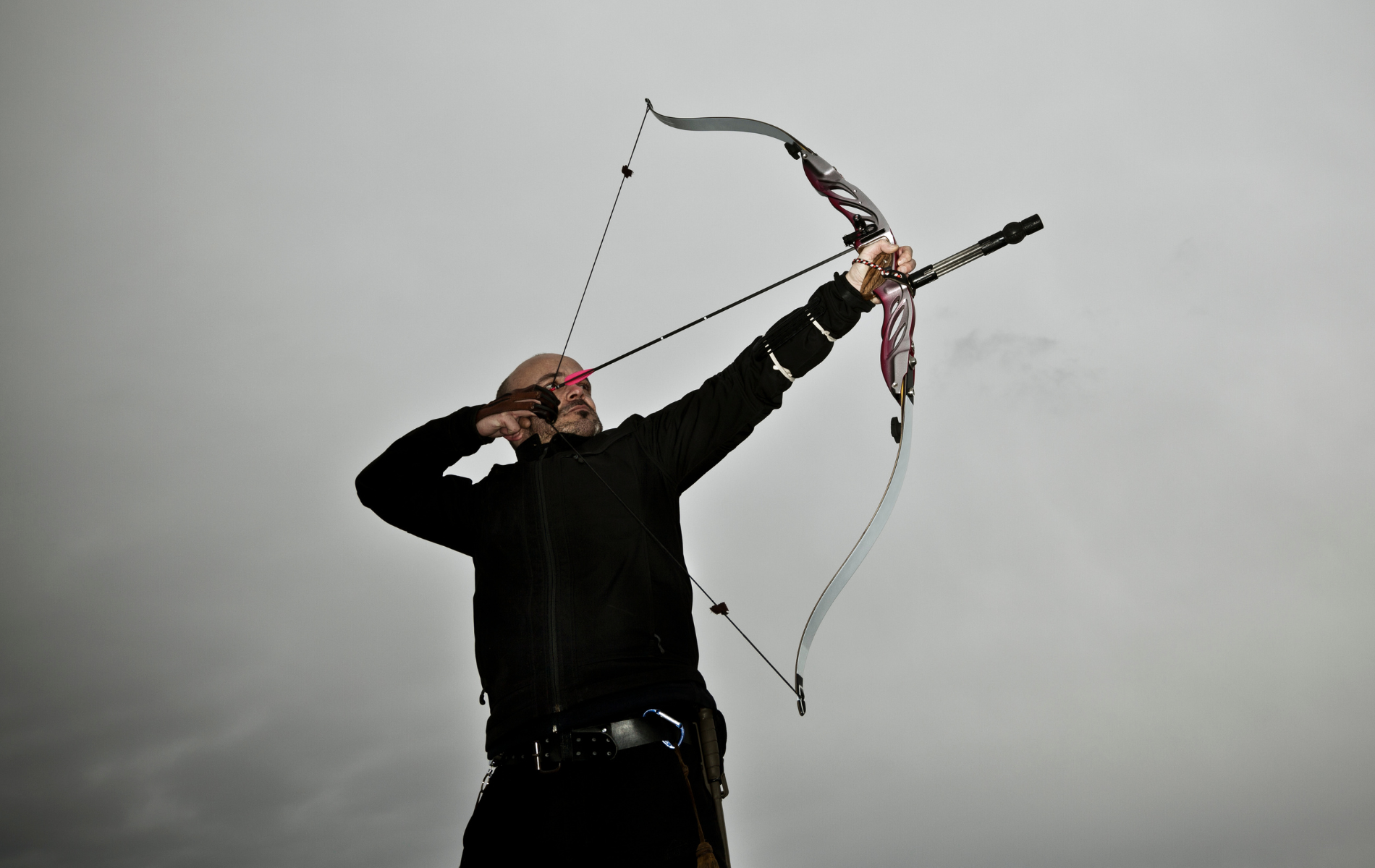 a man shooting with archer