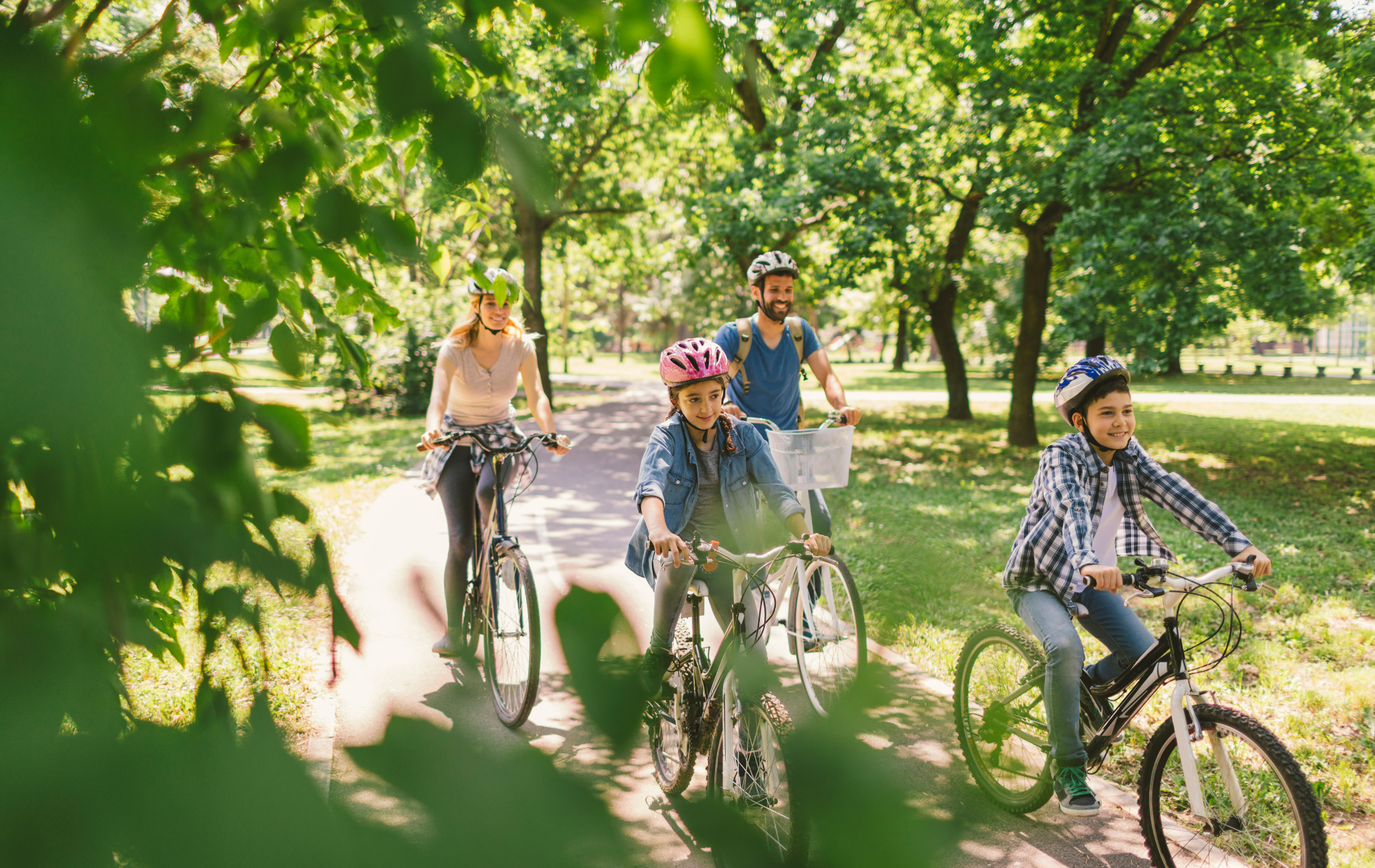 A family is riding bikes in a park.