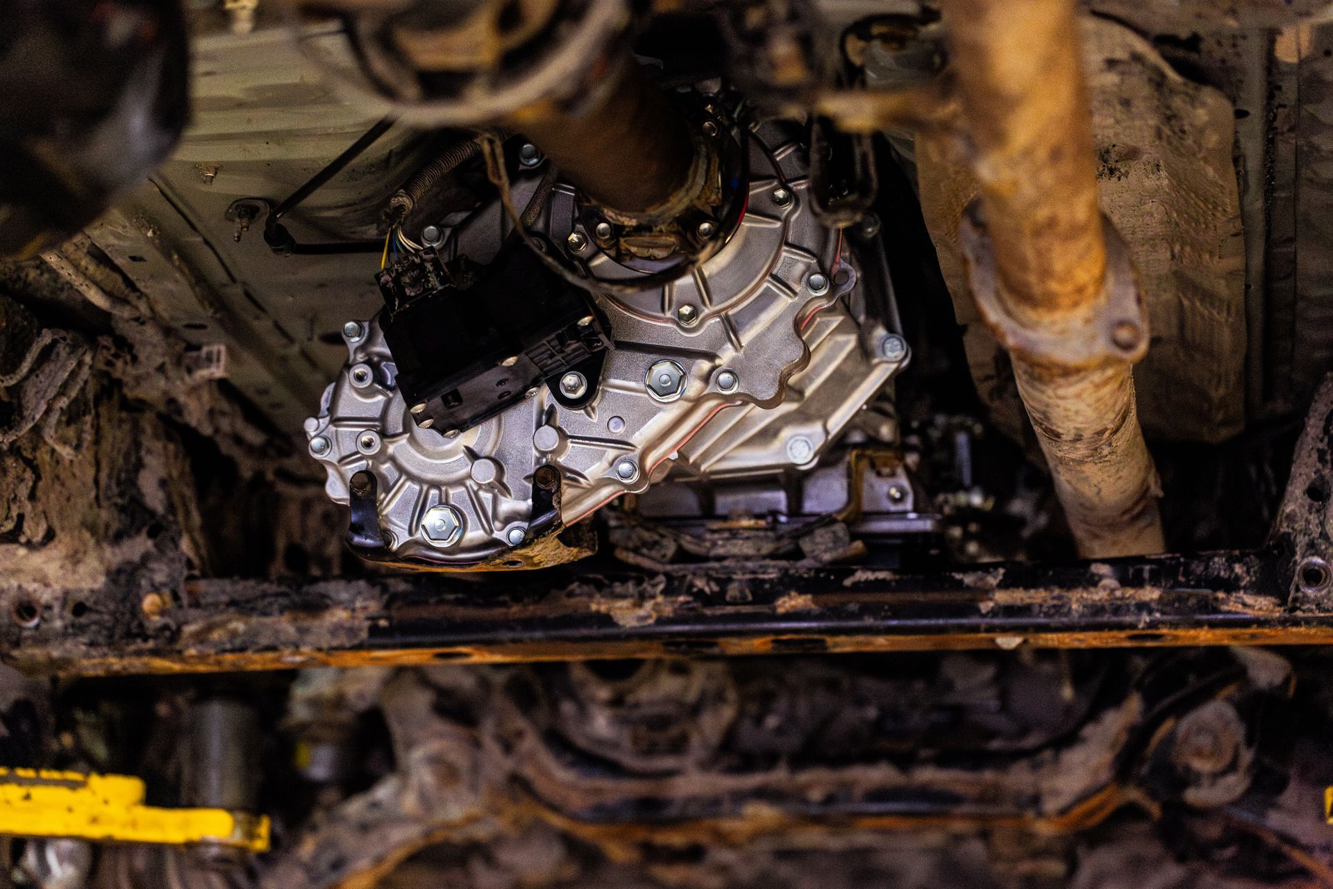 A newly installed transmission system on vehicles' undercarriage.