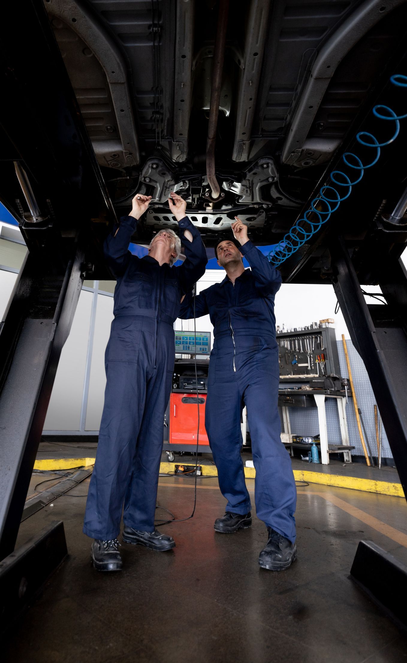 Two Man is Working Underneath a Car — Smyrna, GA —  All Pro Transmission Exchange LLC