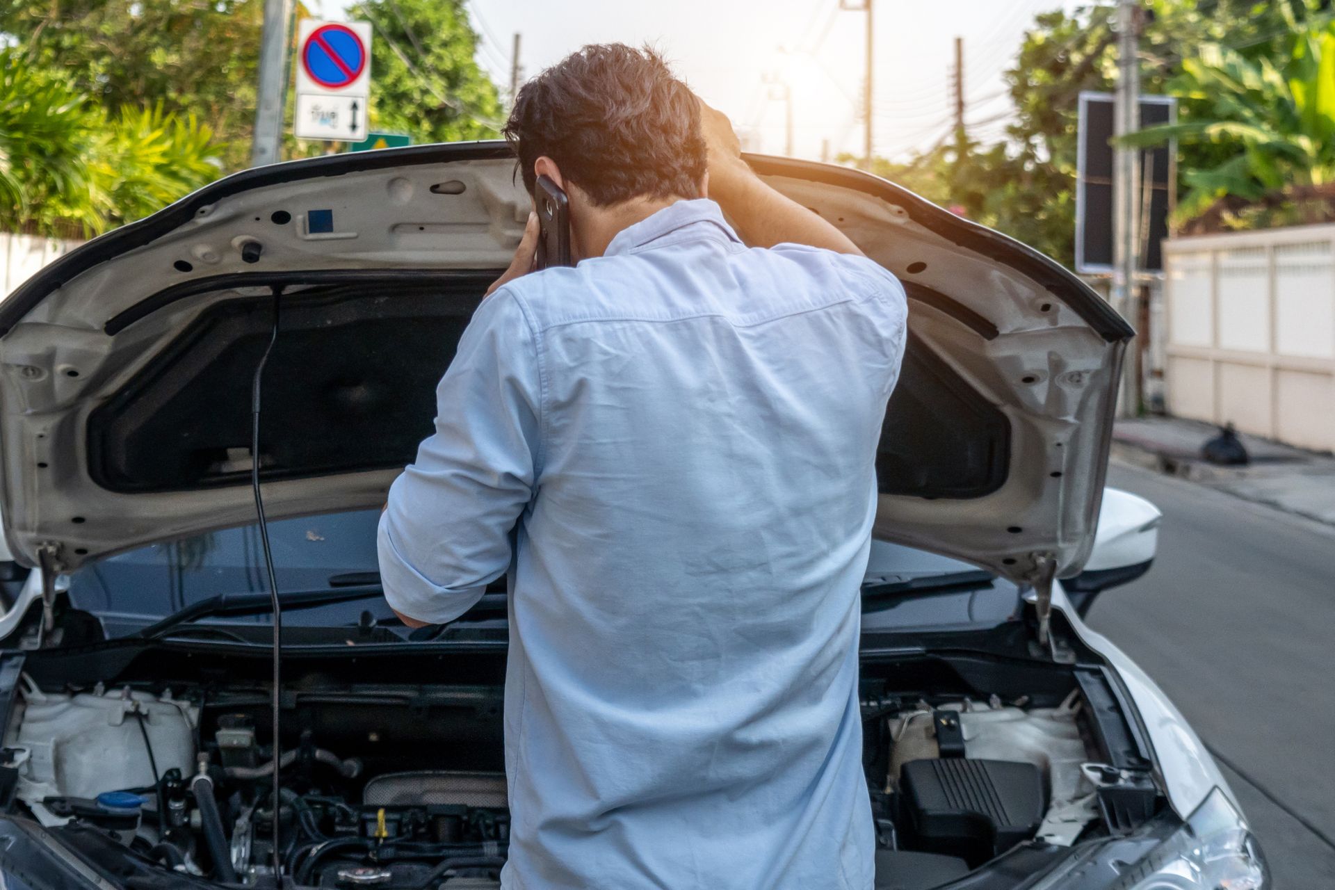 A man calling for assistance after his car broke down due to transmission problems.