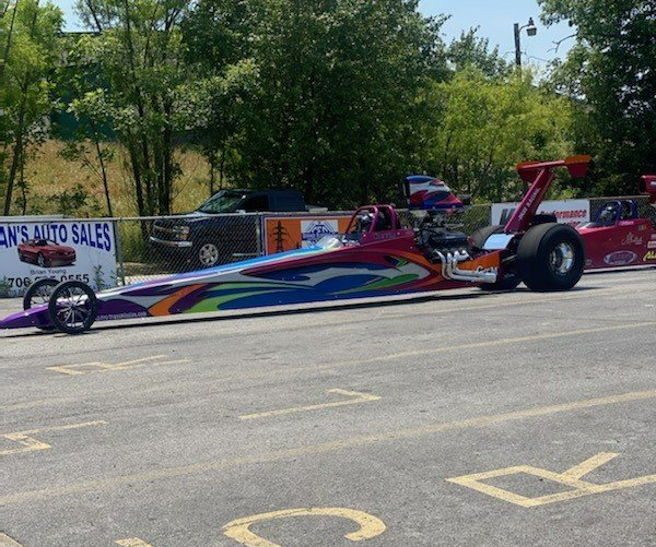 A Dragster is Parked on the Side of the Road Next to a Sign for a Car Dealership — Smyrna, GA — All Pro Transmission