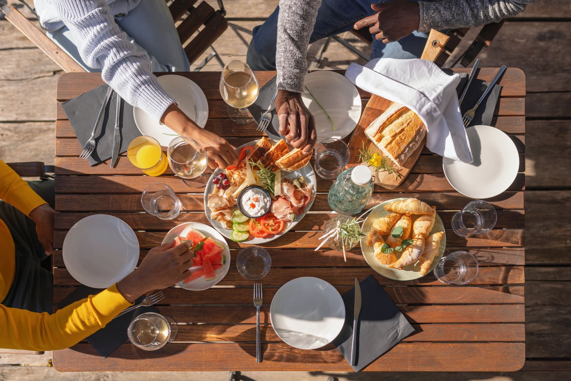 A group of people are sitting at a table eating food.