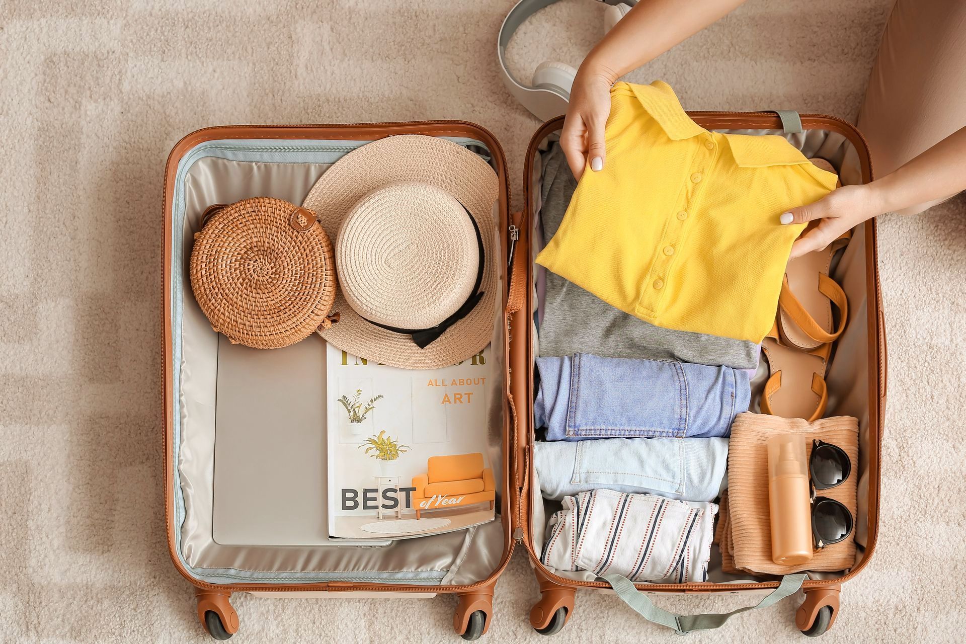 A person is packing a suitcase for a trip.