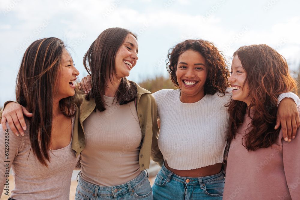 Three women are taking a selfie together and smiling.