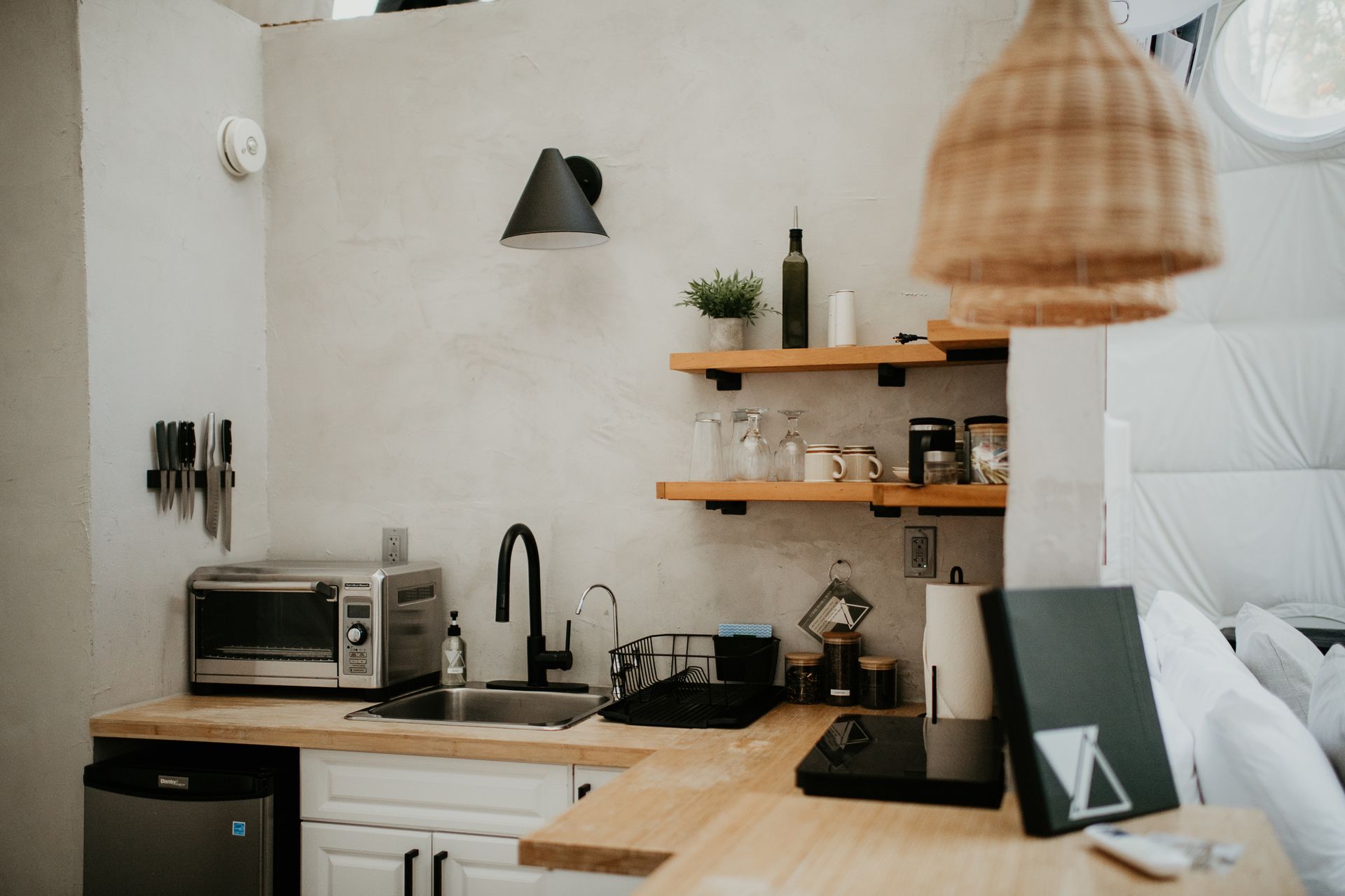 A kitchen with a sink , microwave , and dishwasher.