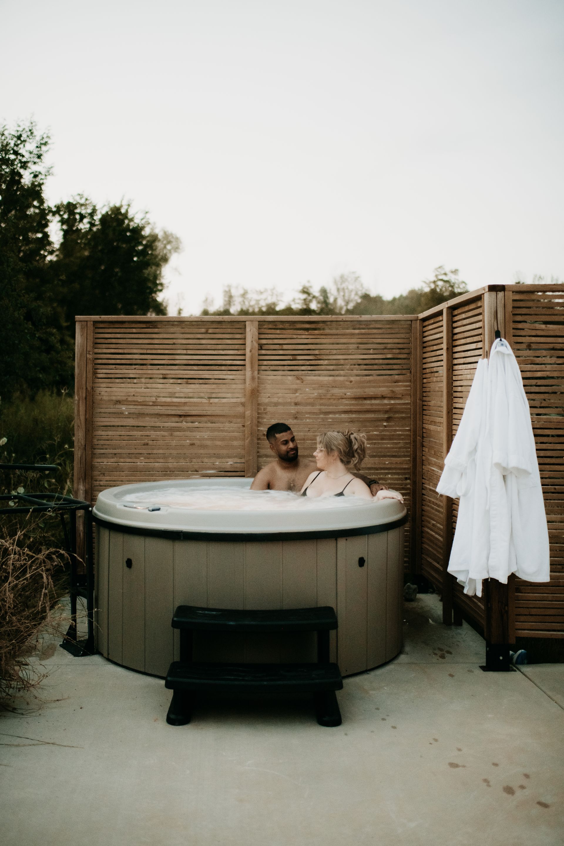 A man and a woman are sitting in a hot tub.