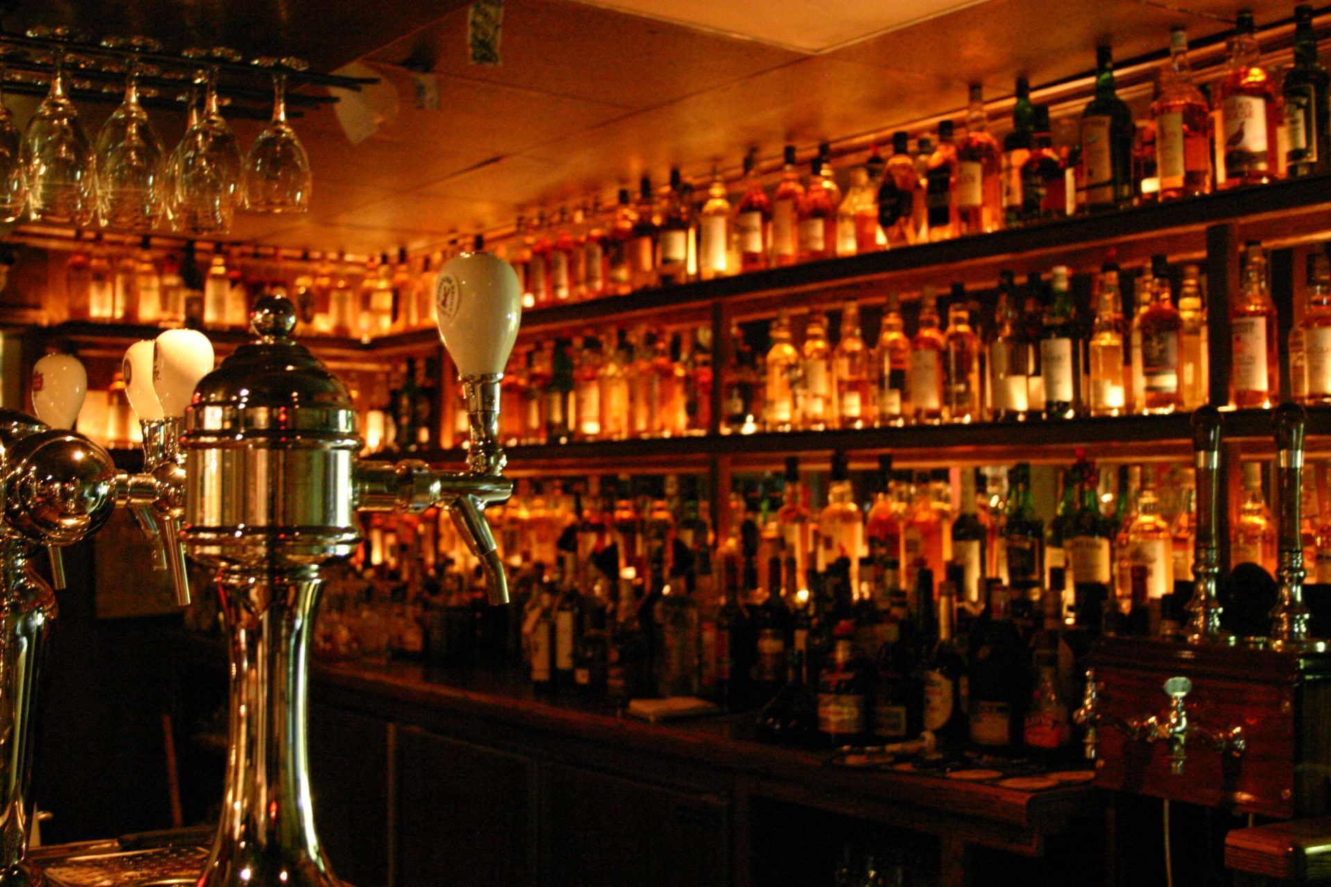 a bar filled with lots of bottles and glasses