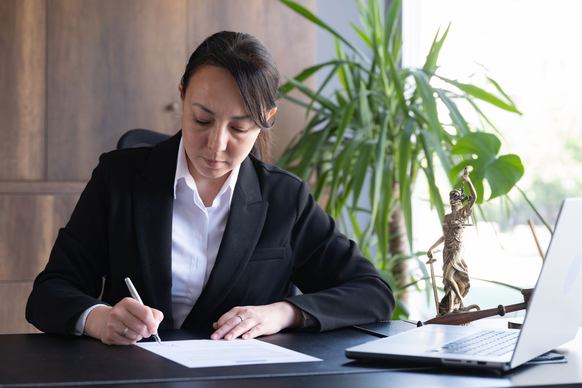 A legal advisor is signing a document.