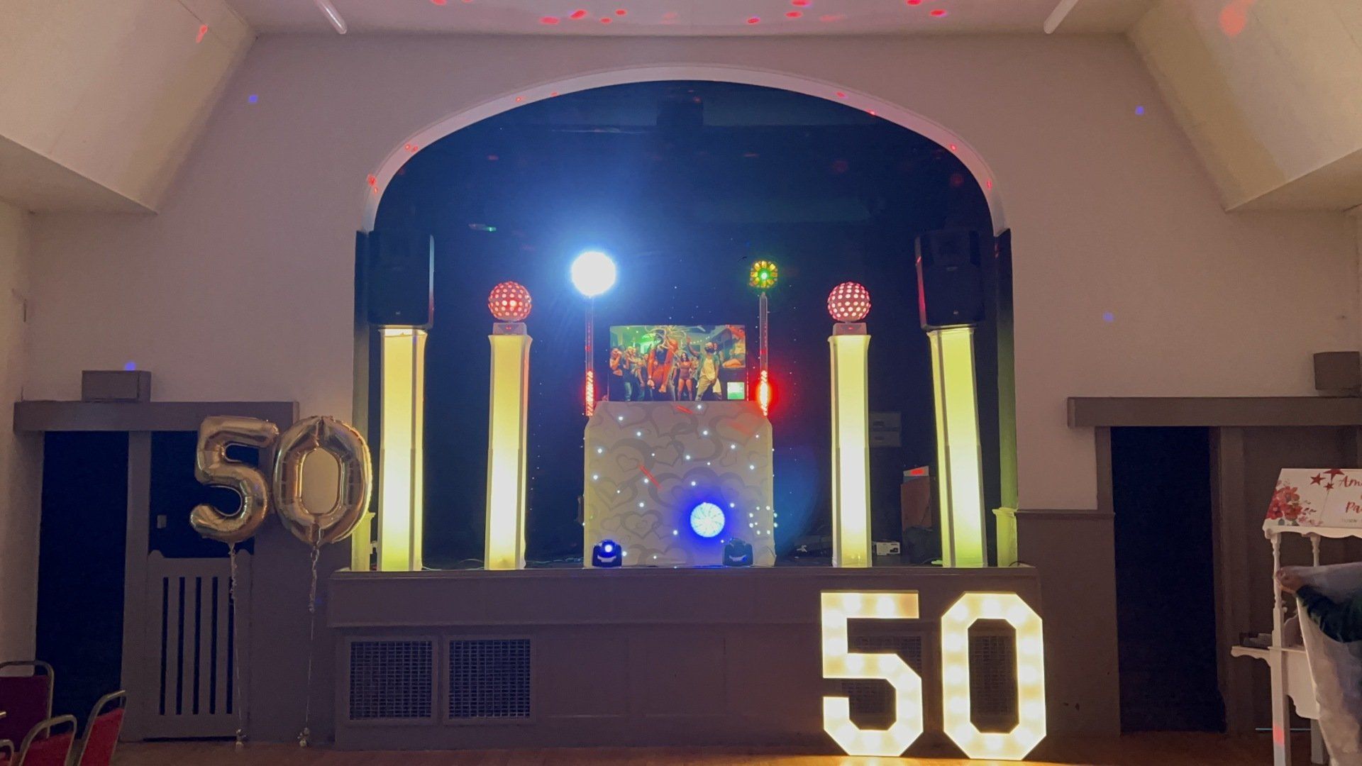 Performing at a 50th birthday party using a gold theme disco setup