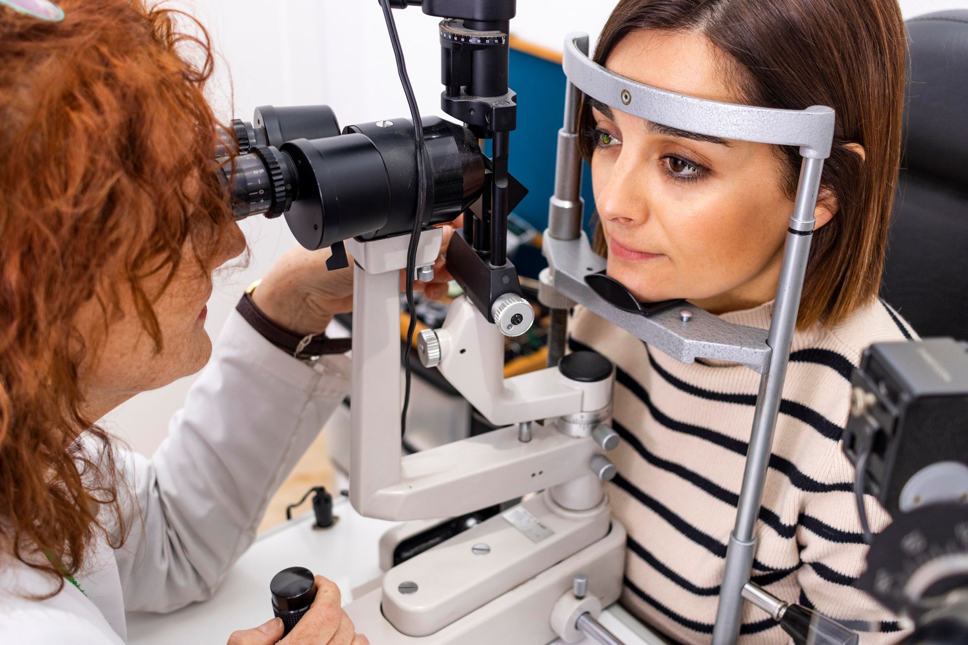 Man having eye exam with slit lamp.