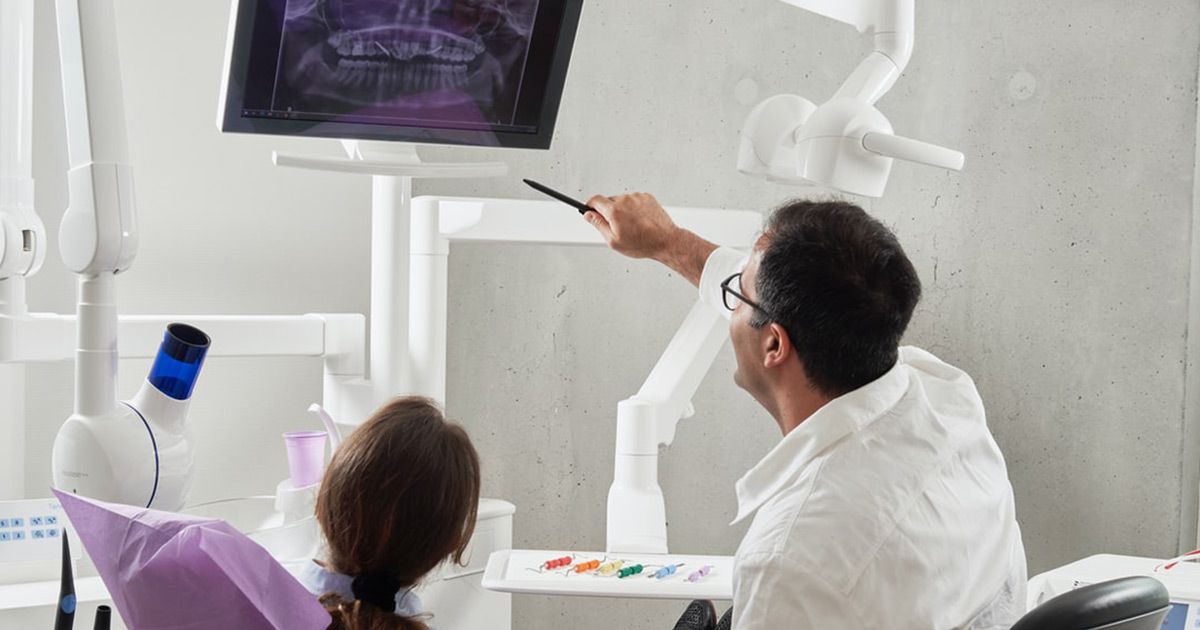 dentist showing patient x-ray