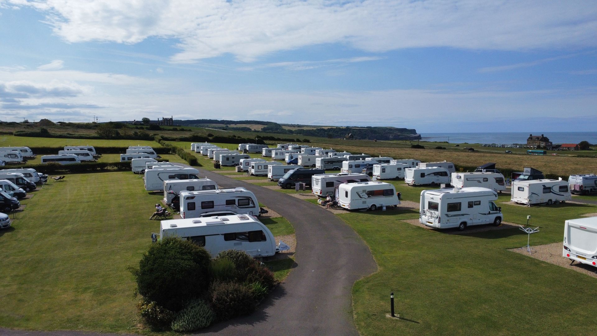There is a house on the cliff overlooking the ocean.