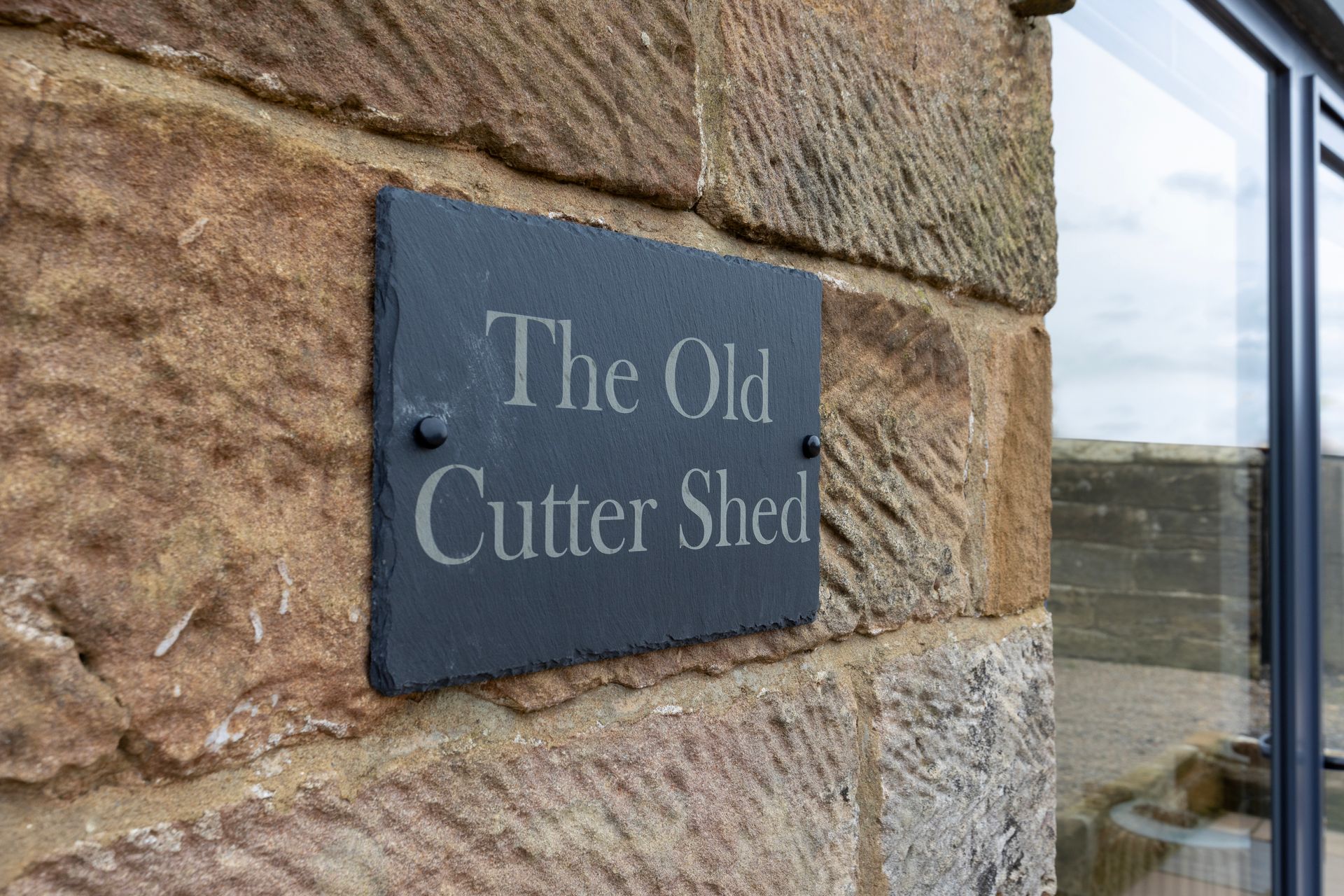 A sign on a stone wall says the old cutter shed.