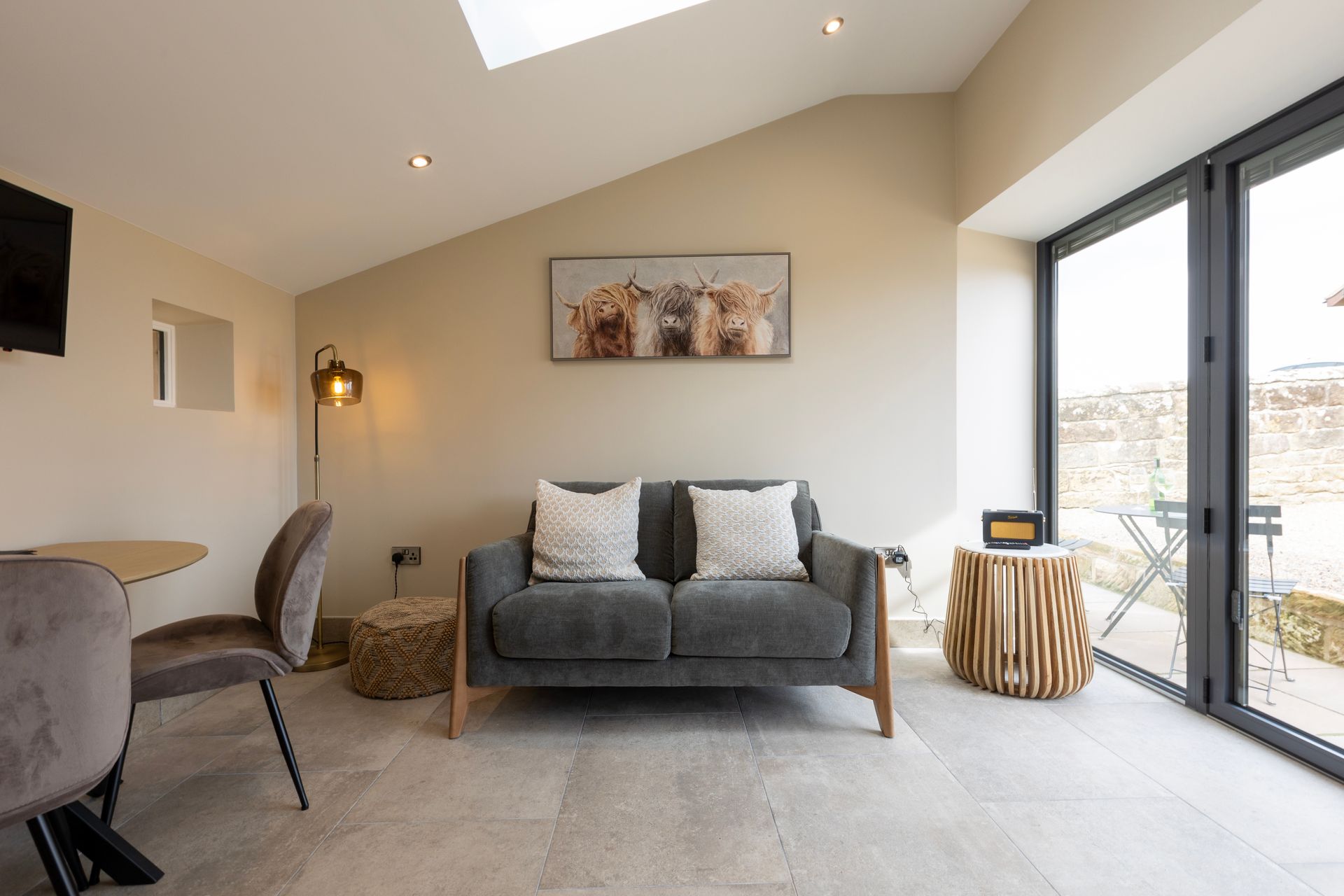 A living room with a couch , chairs and a table.