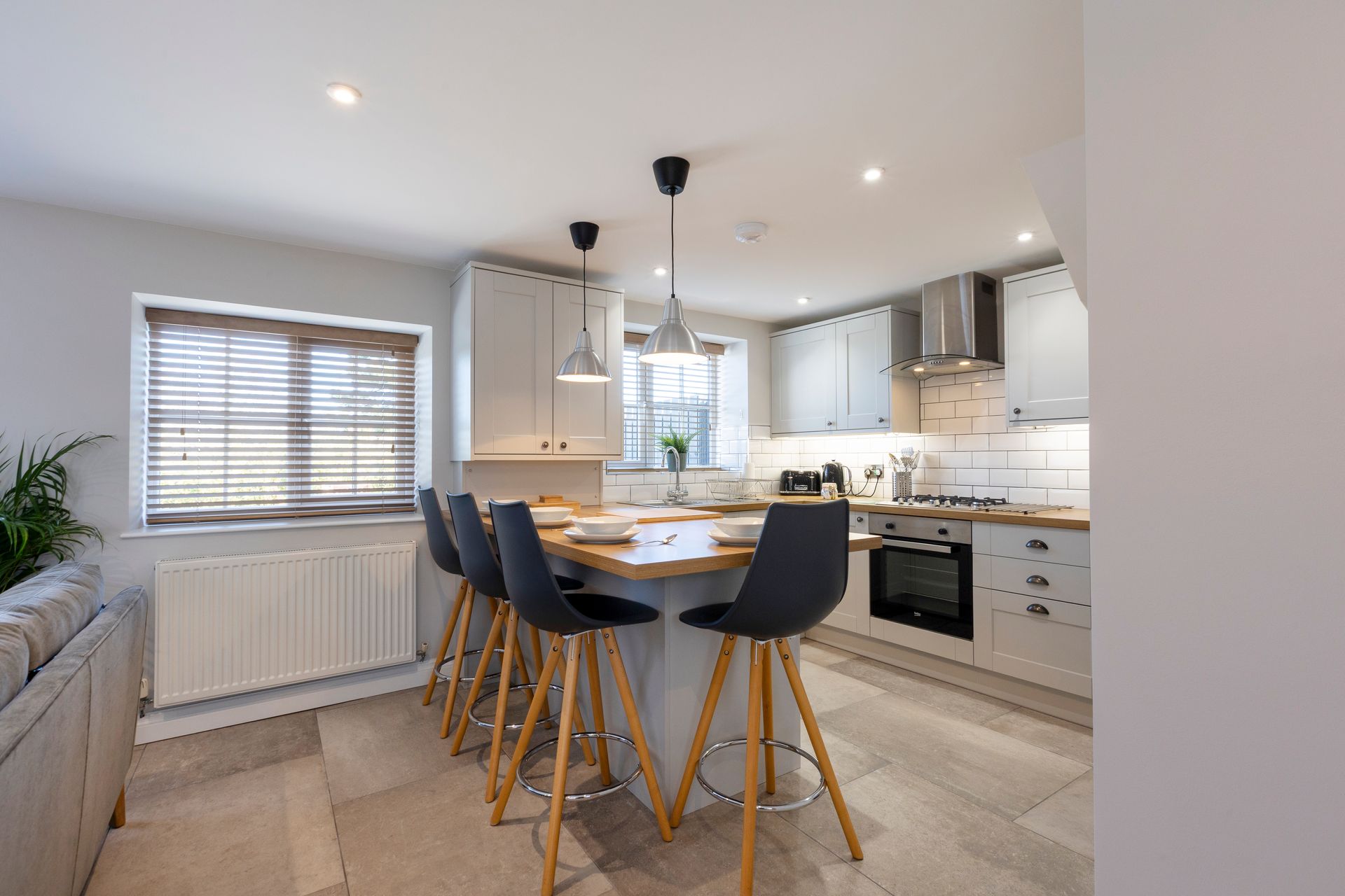 A kitchen with a table and chairs in it.