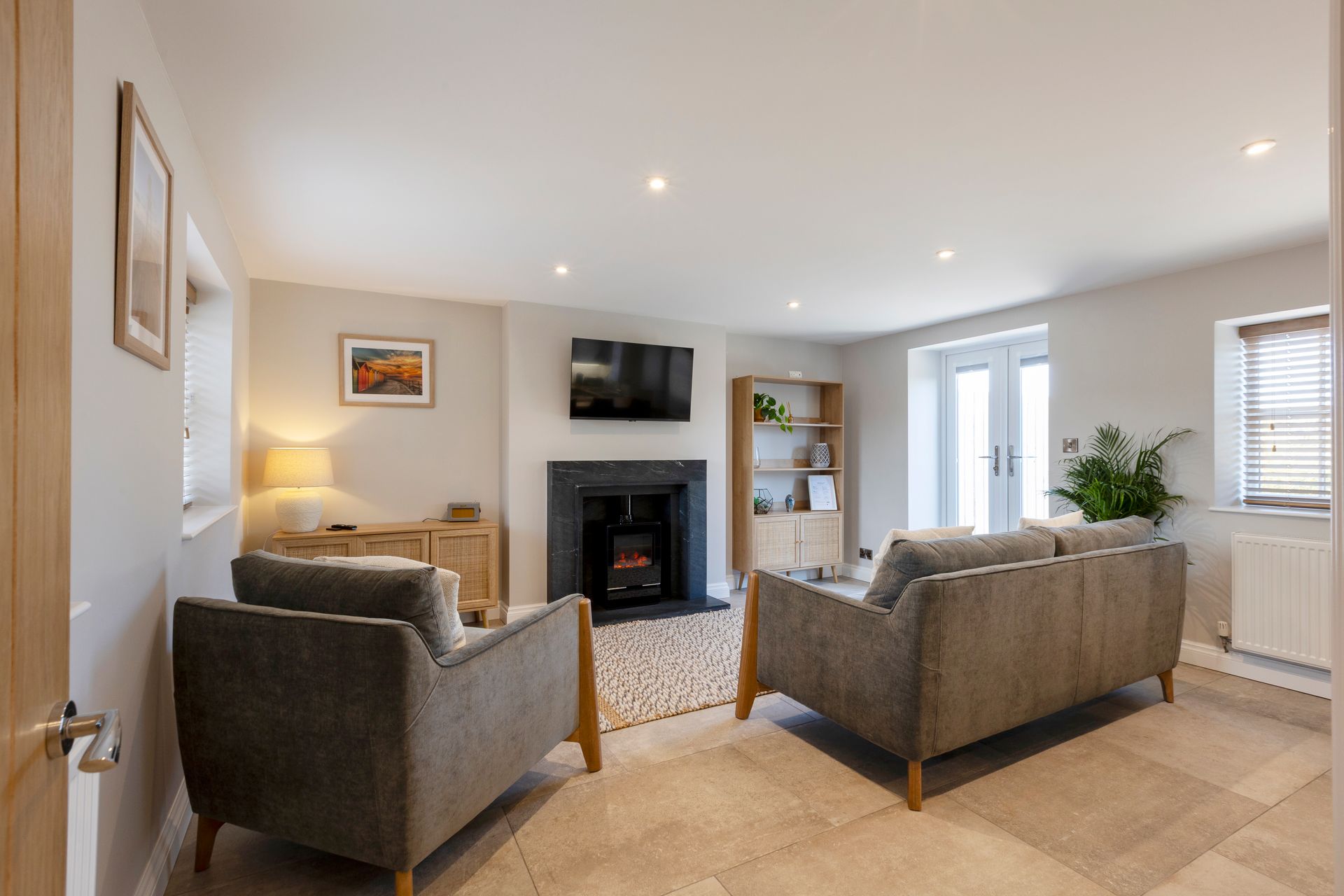 A living room with two couches and a fireplace