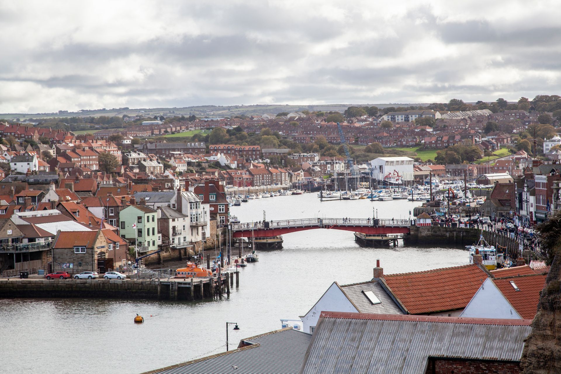 An aerial view of a city with a bridge over a body of water.