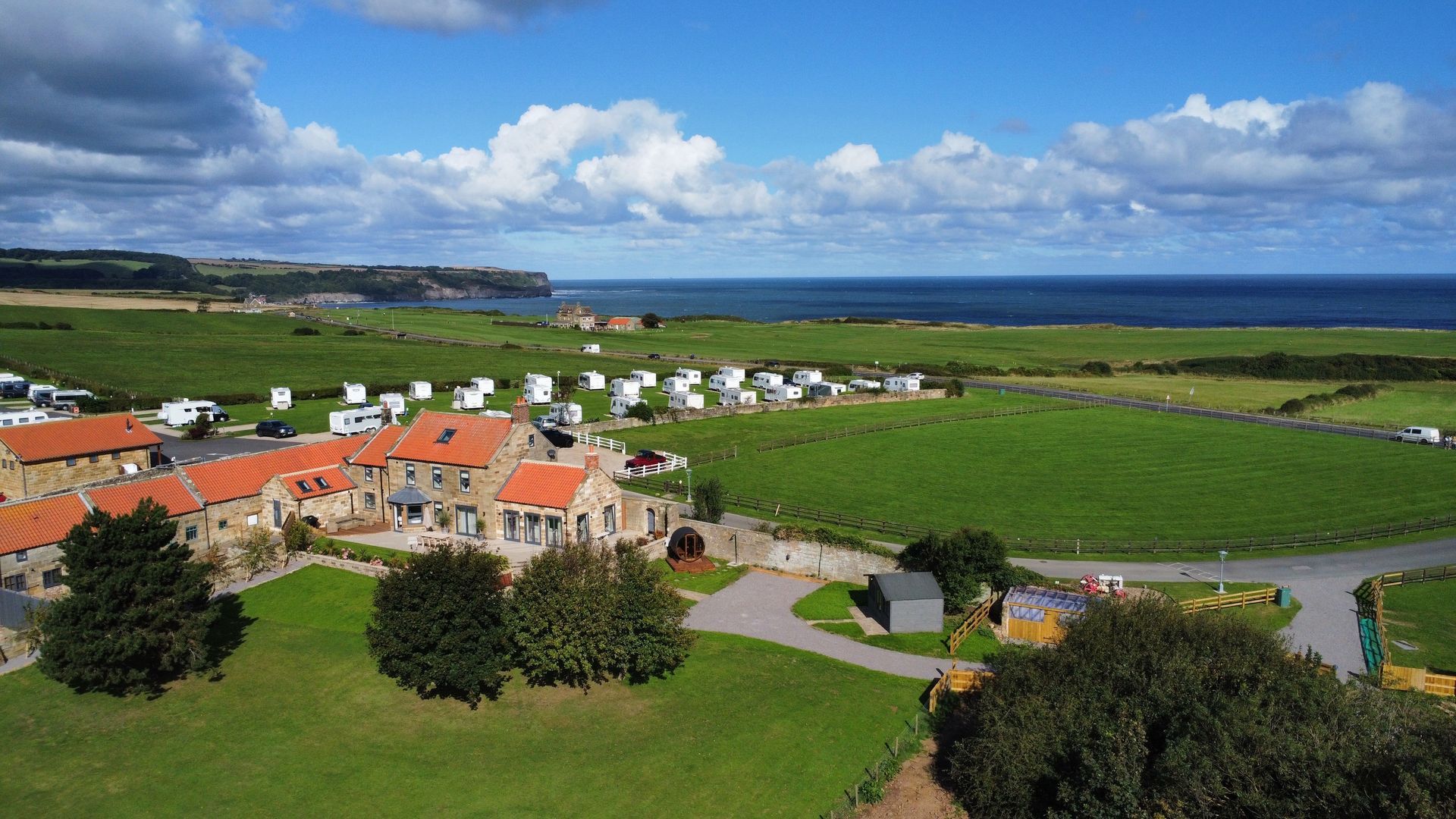 An aerial view of the caravan park next to the ocean.