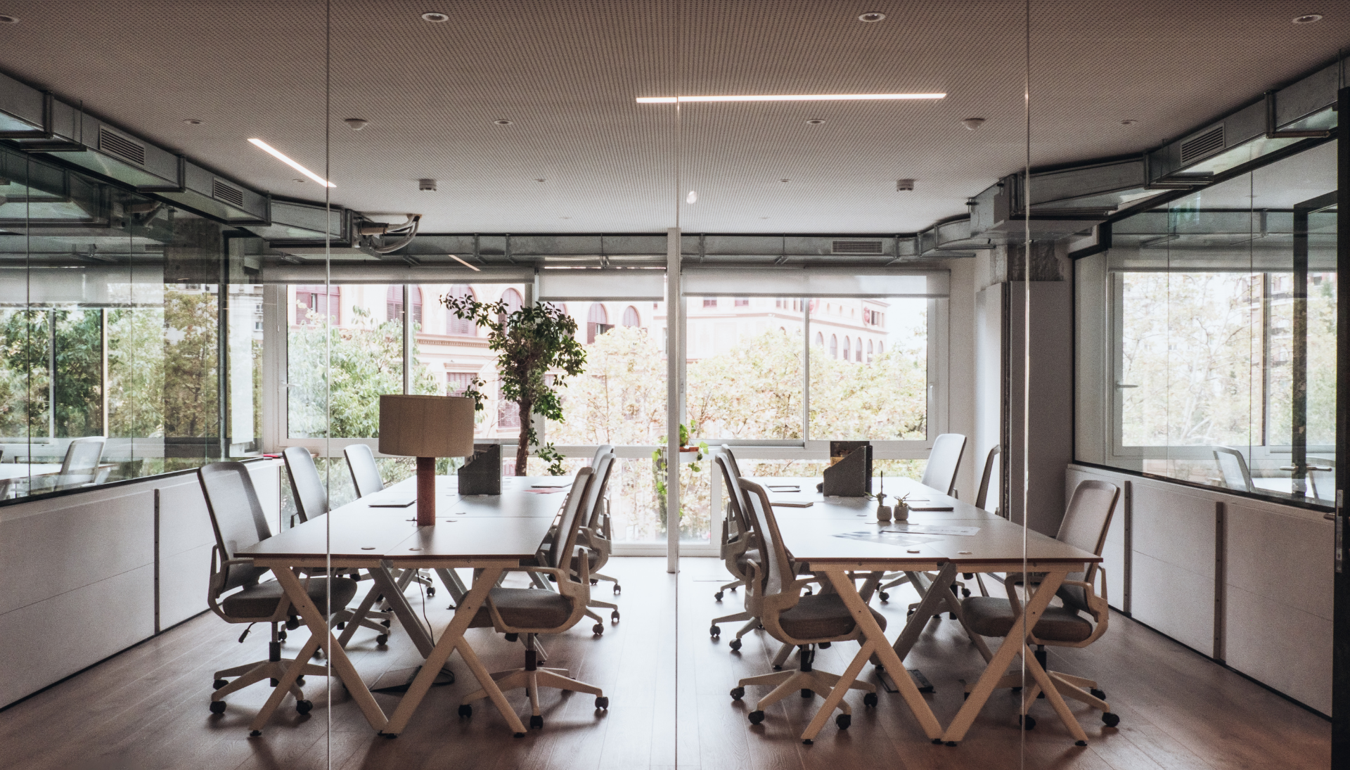 A conference room with a long table and chairs in it.