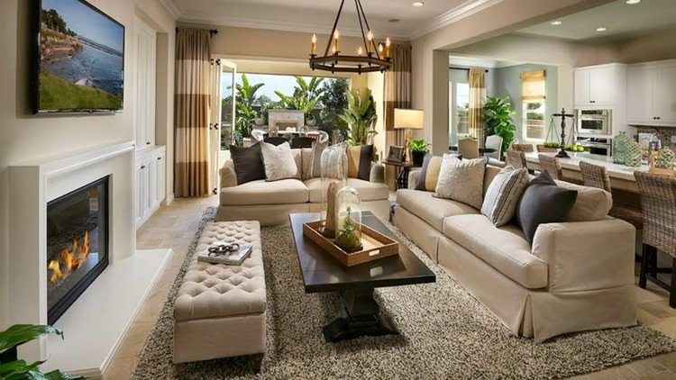 A living room with a couch , coffee table , fireplace and television.