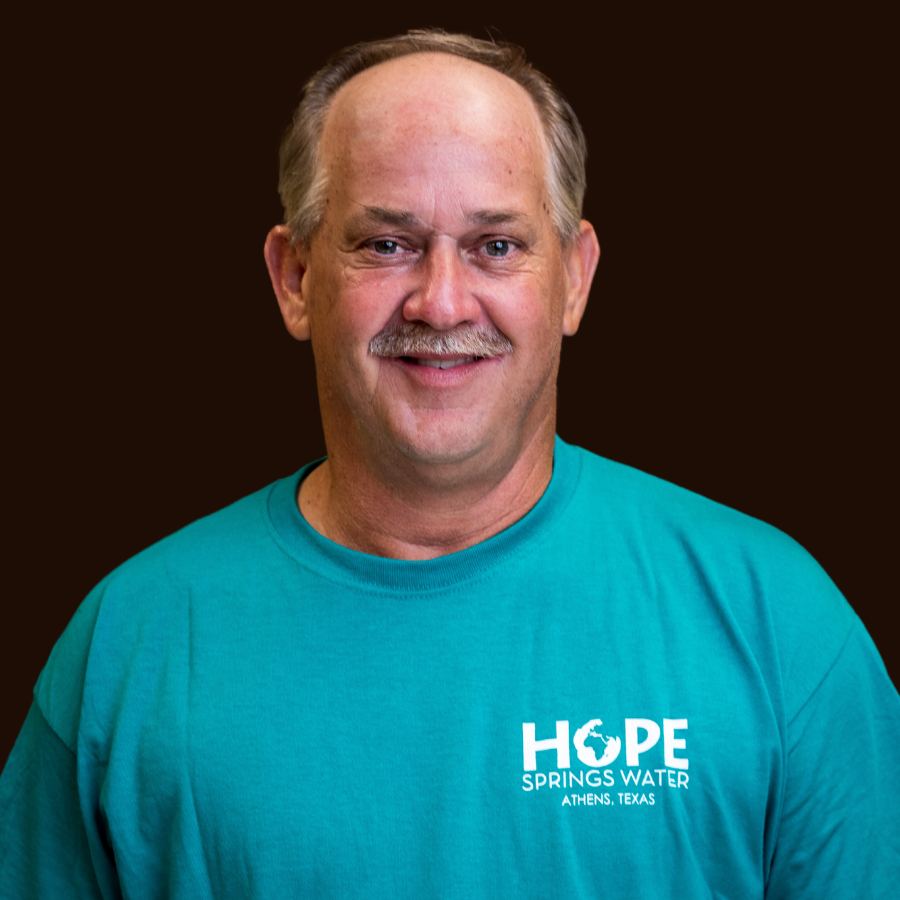 A man wearing a blue shirt that says hope springs water