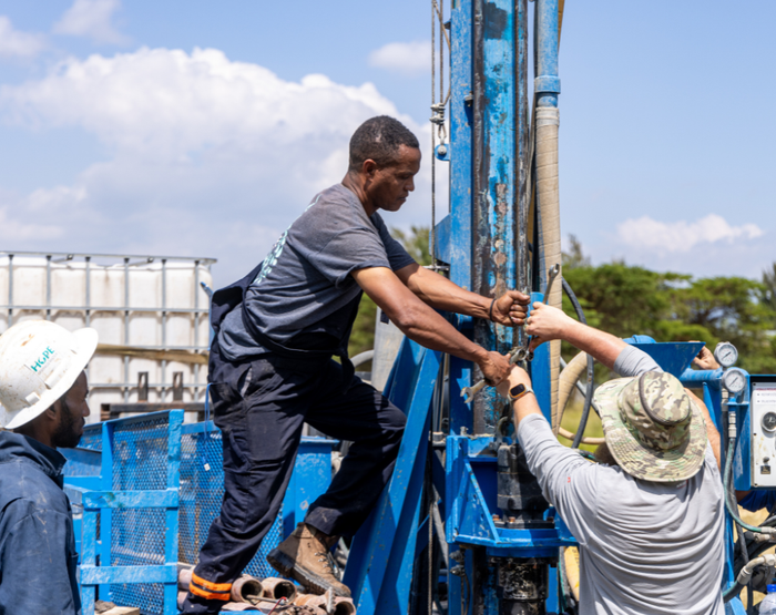 A group of men are working on a drilling rig.