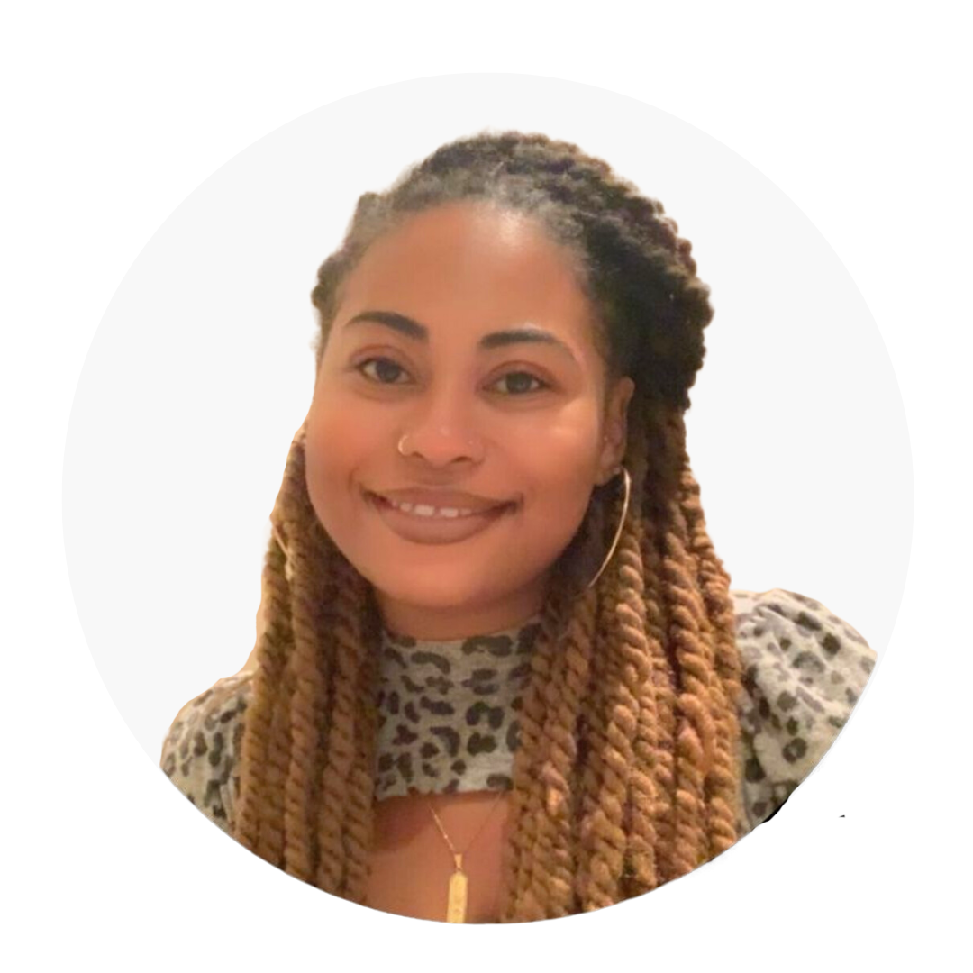 Woman with brown twisted braids, smiling, wearing a leopard print top and gold hoop earrings.