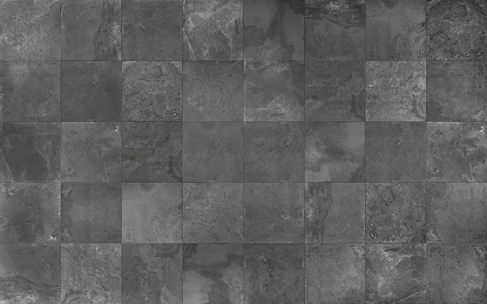 A black and white photo of a gray tile floor.