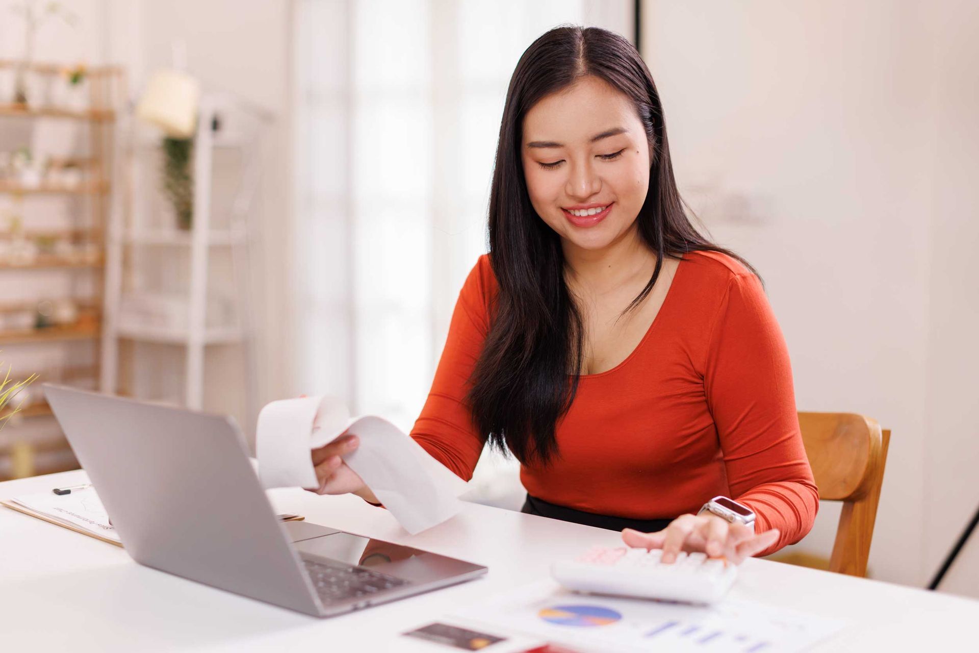 Woman calculating expenses showcasing personal installment loans with notes, payments table.