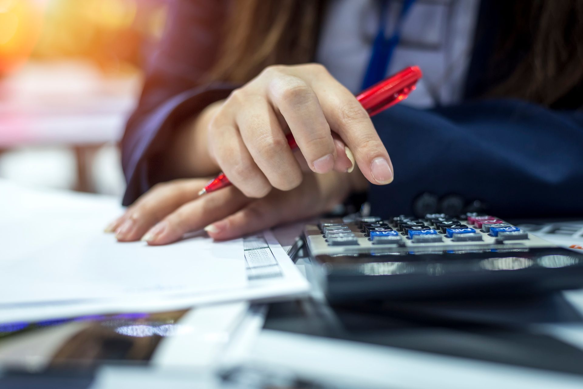 A person holding a pen over a piece of paper | Personal Installment Loans in Tulsa Ok