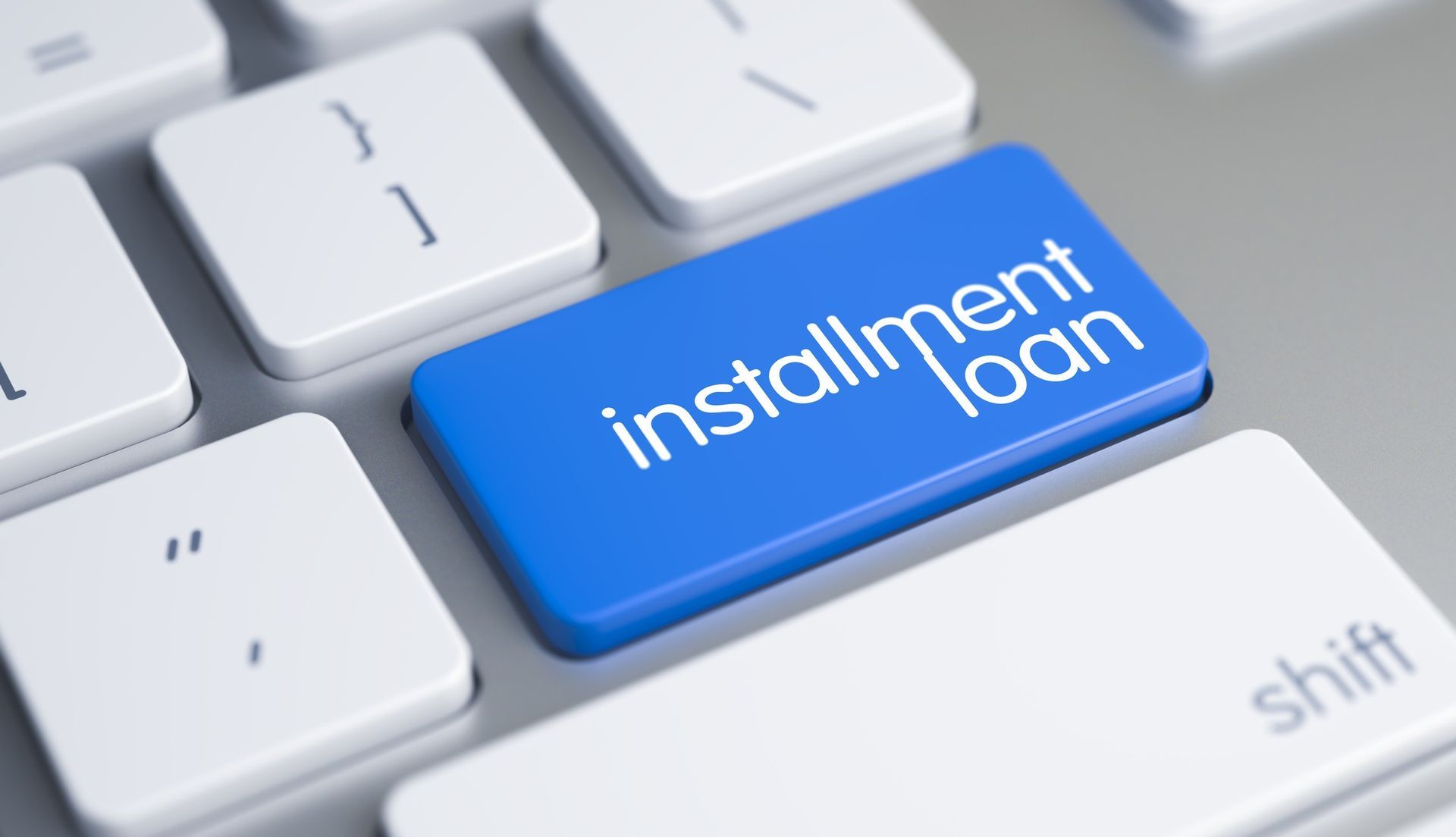 Bright blue Enter the key with “Installment Loan” glowing softly above the keyboard.