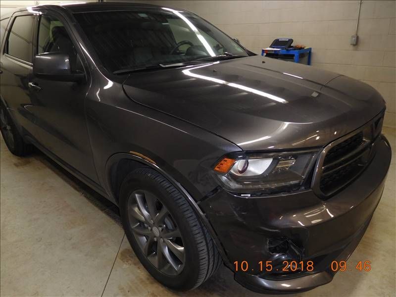 A gray dodge durango is parked in a garage on october 15 2018