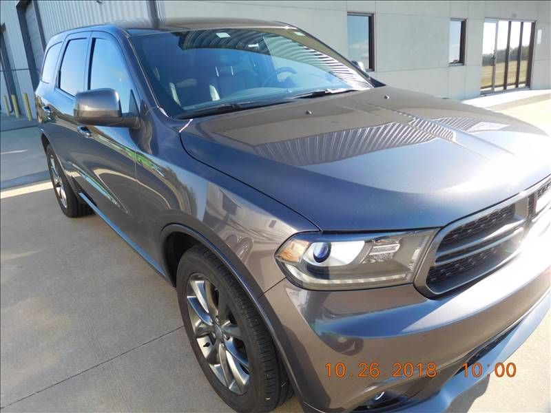 A dodge durango is parked in front of a building