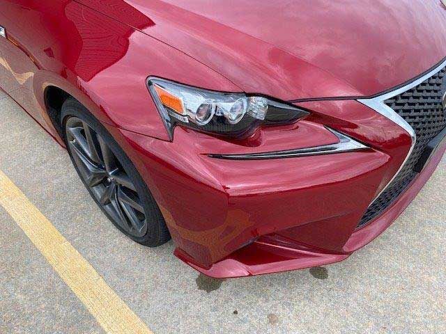 A red car is parked in a parking lot.