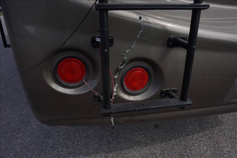 A car with a ladder attached to the back of it.