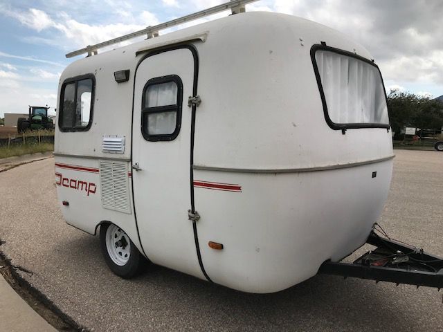 A white trailer with the word camp on it